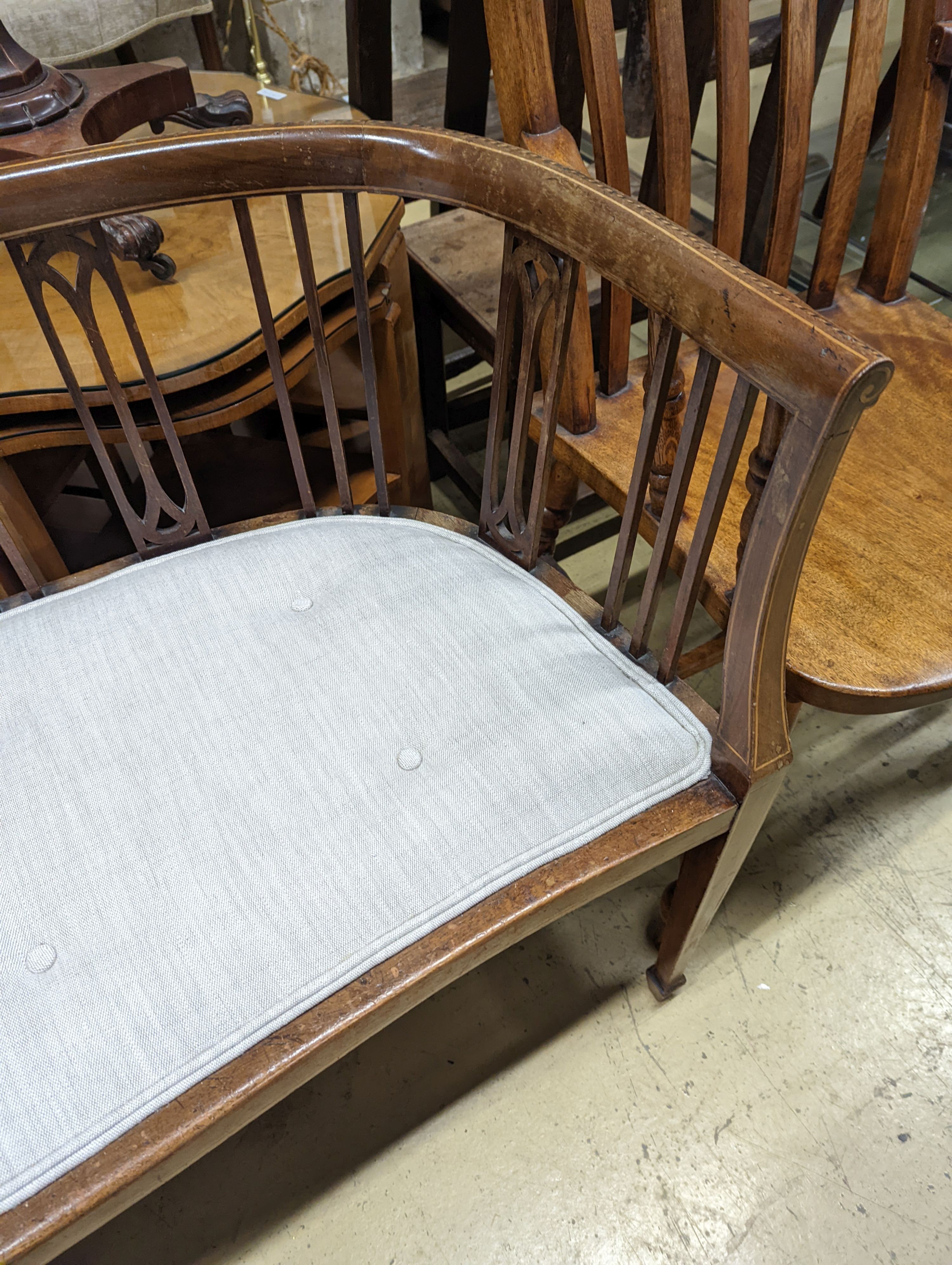 An Edwardian inlaid mahogany slat back settee, length 164cm, depth 47cm, height 74cm